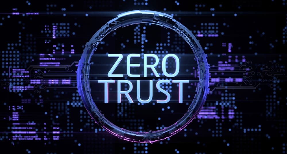 The words zero trust in a circle with simulated computer architecture as the background.